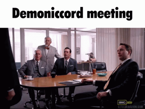 Group of Men Sitting at Table Demonicord Meeting