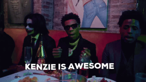 Group Of Men Sitting At Table Saying Kenzie Is Awesome GIF