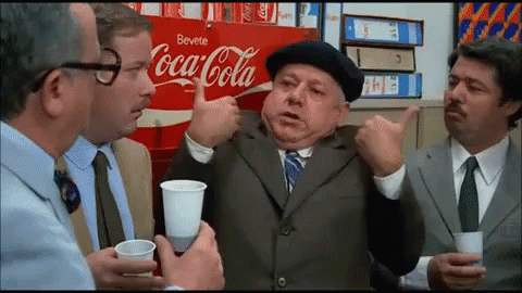 Group of Men Sitting by Coca Cola Ad