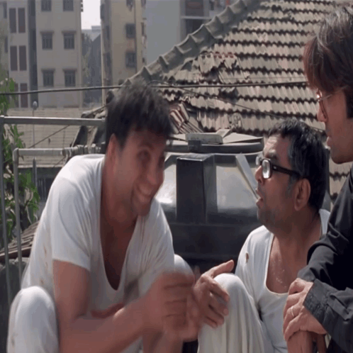 Group of Men Sitting on Roof Talking