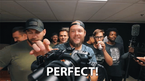 Group of Men Standing Around Camera Perfect