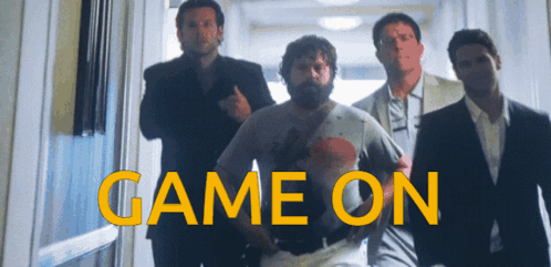 Group of Men Walking Hallway Saying Game On