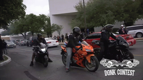 Group of Motorcycle Riders Riding Down Street With Words Donk Contest on Bottom