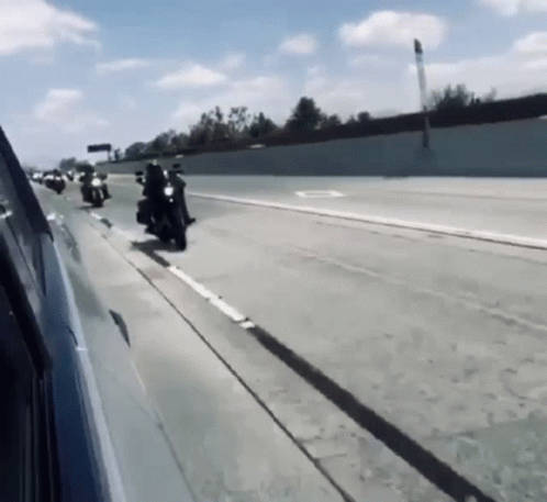 Group of Motorcycles Riding Down Highway