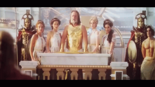 Group of People Around Podium With Man in Gold Vest