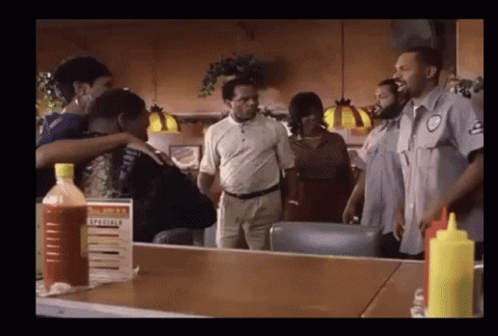 Group Of People Around Table With Specials Sign GIF