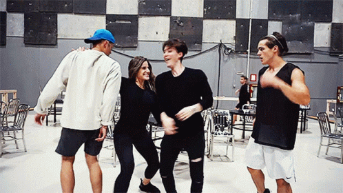 Group of People Dancing in Room With Chairs