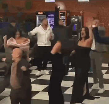 Group of People Dancing in Room With Checkered Floor