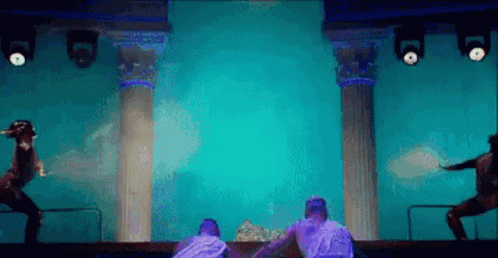 Group of People Dancing on Blue Stage