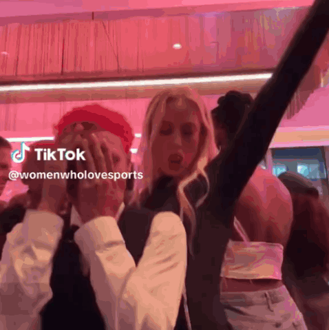 Group of People Dancing on Pink Background With TikTok Logo