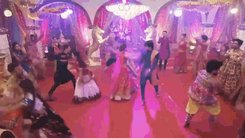 Group of People Dancing on Red Carpet Under Purple Lights