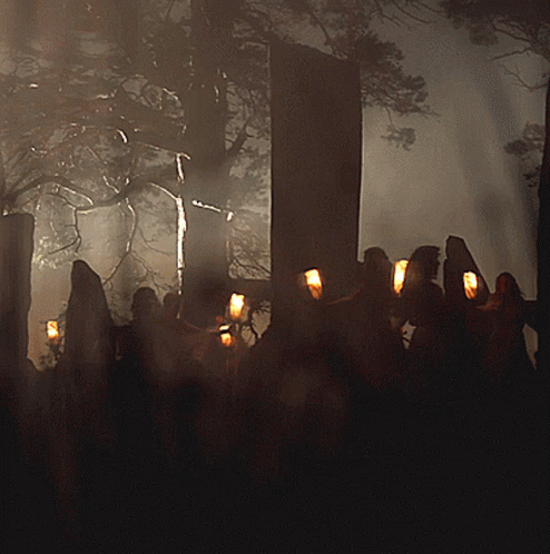 Group of People Holding Candles in Dark