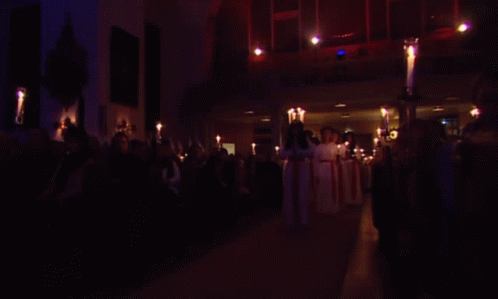 Group of People Holding Candles in Dark Room