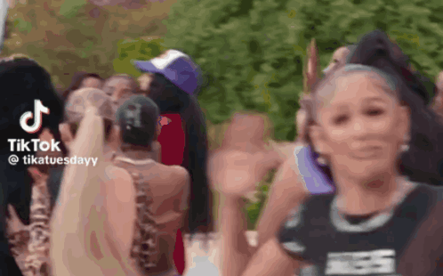 Group of People in a Crowd Sharing TikTok Video