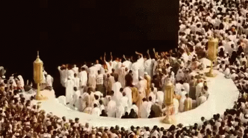 Group of People in Circle in Front of Mosque