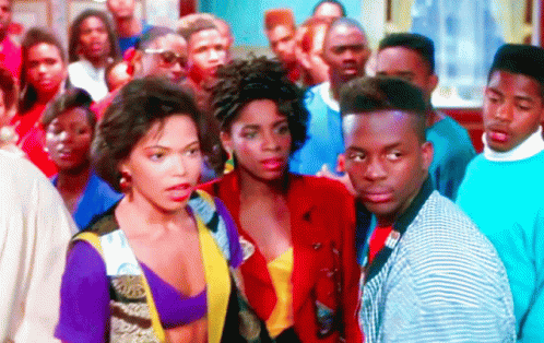 Group of People in Crowd With Woman in Purple Top