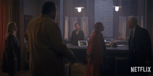 Group Of People In Dark Room With Netflix Logo GIF
