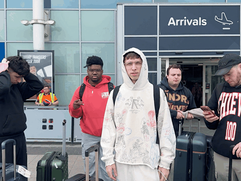 Group of People in Front of Arrivals Sign