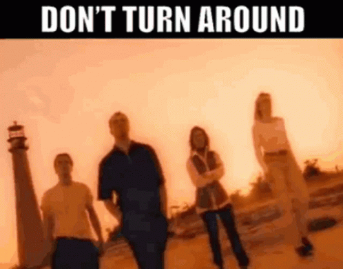 Group of People in Front of Lighthouse Don't Turn Around