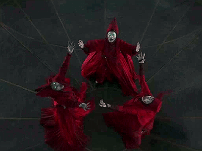 Group of People in Red Robes Standing in Circle