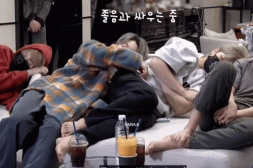 Group of People Laying on Couch With Bottle of Nana K
