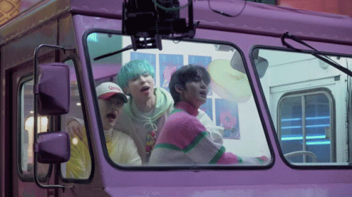 Group of People Looking Out of Purple Bus