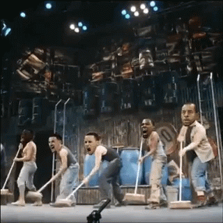 Group of People on Stage with Mops