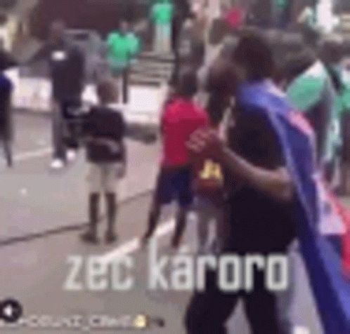 Group of People on Street with Zec Kaoro Text