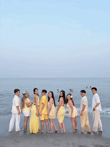 Group of People Posing on Sandy Beach