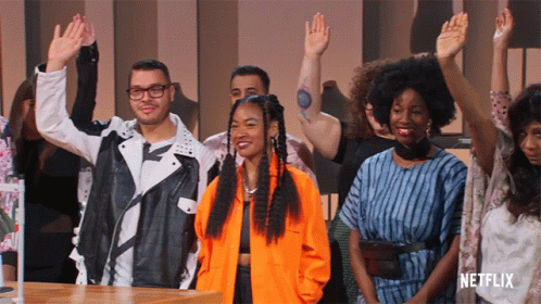 Group of People Raising Hands With Netflix Logo
