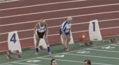 Group of People Running on Track With Numbers 1-4