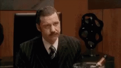 Group Of People Sitting Around Table Having Meeting GIF
