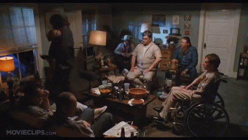 Group of People Sitting Around Table With Movieclips.com