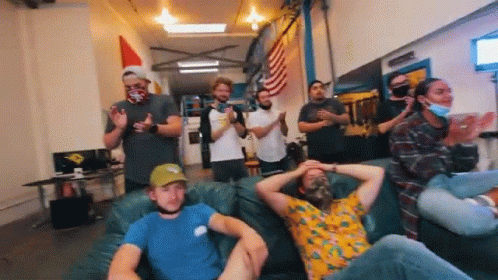 Group of People Sitting on Couch Clapping