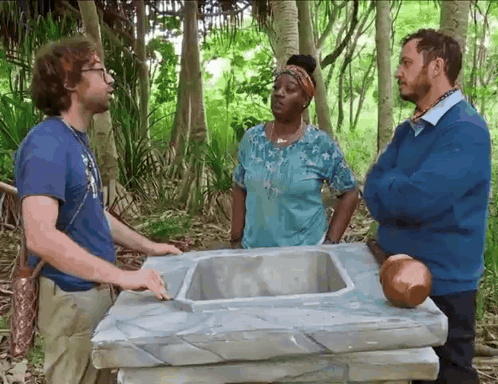 Group of People Standing Around Sink in Woods