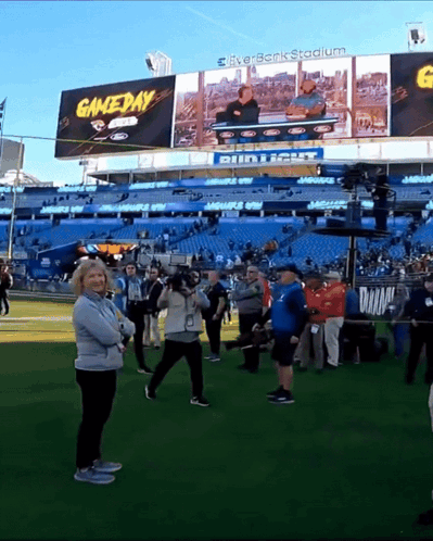 Group of People Standing in Front of Gameday Stadium