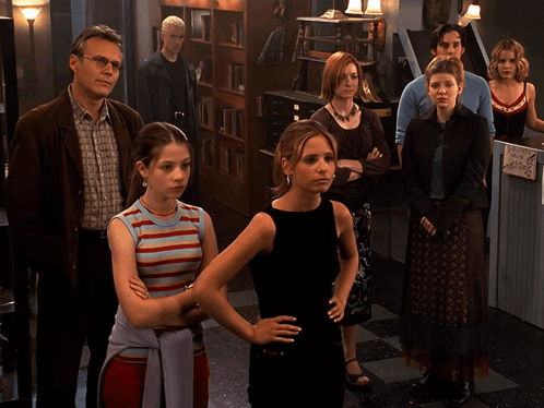 Group of People Standing in Room Saying We're Family