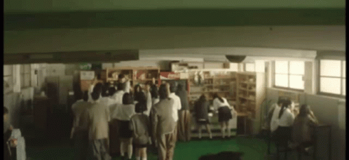 Group Of People Standing In School Hallway GIF