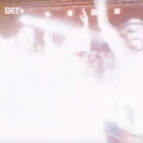 Group of People Standing on Stage With BET Logo