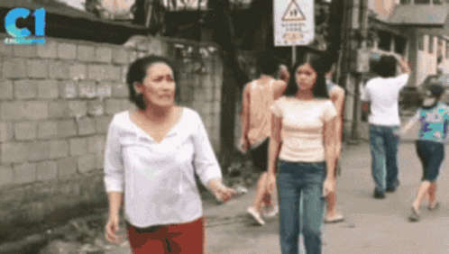 Group Of People Walking Down Street With C1 Logo GIF