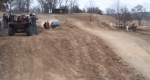 Group Of People Watching Jeep On Dirt Track GIF