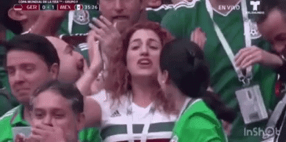 Group of People Watching Soccer Woman Covering Mouth