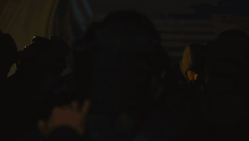 Group of People With Spotlight in Dark Room