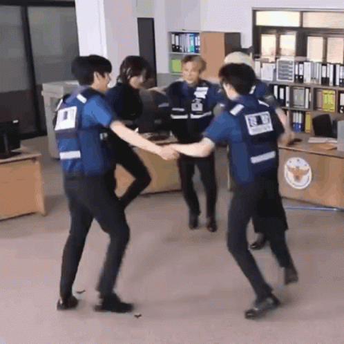 Group of Police Officers Holding Hands in Office