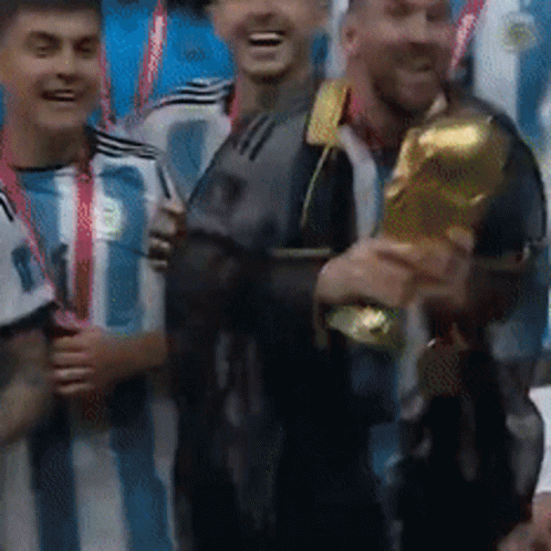 Group of Soccer Players Holding Trophy and Smiling
