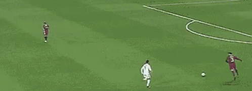 Group of Soccer Players Playing on Green Field