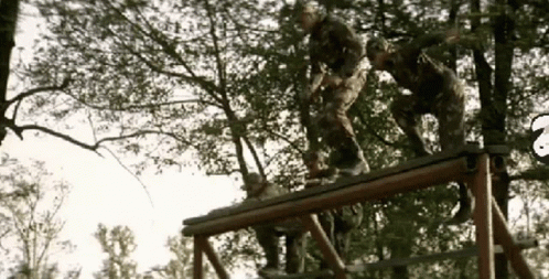 Group Of Soldiers Standing On Wooden Structure GIF