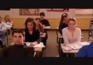Group Of Students Sitting At Desks In Classroom GIF