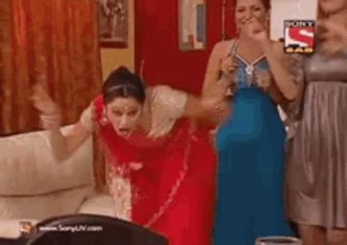 Group Of Women Dancing, One In Red Saree GIF