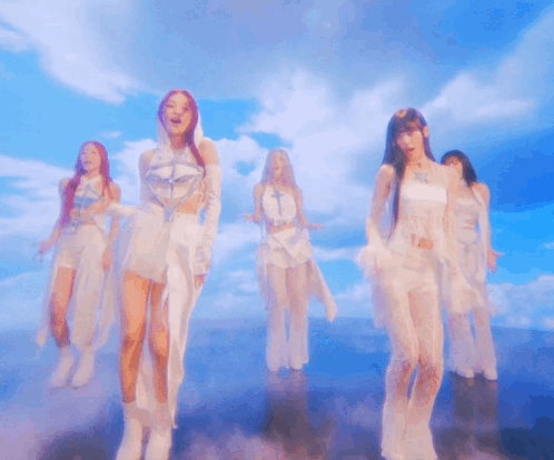 Group of Women Dancing Under Cloudy Sky